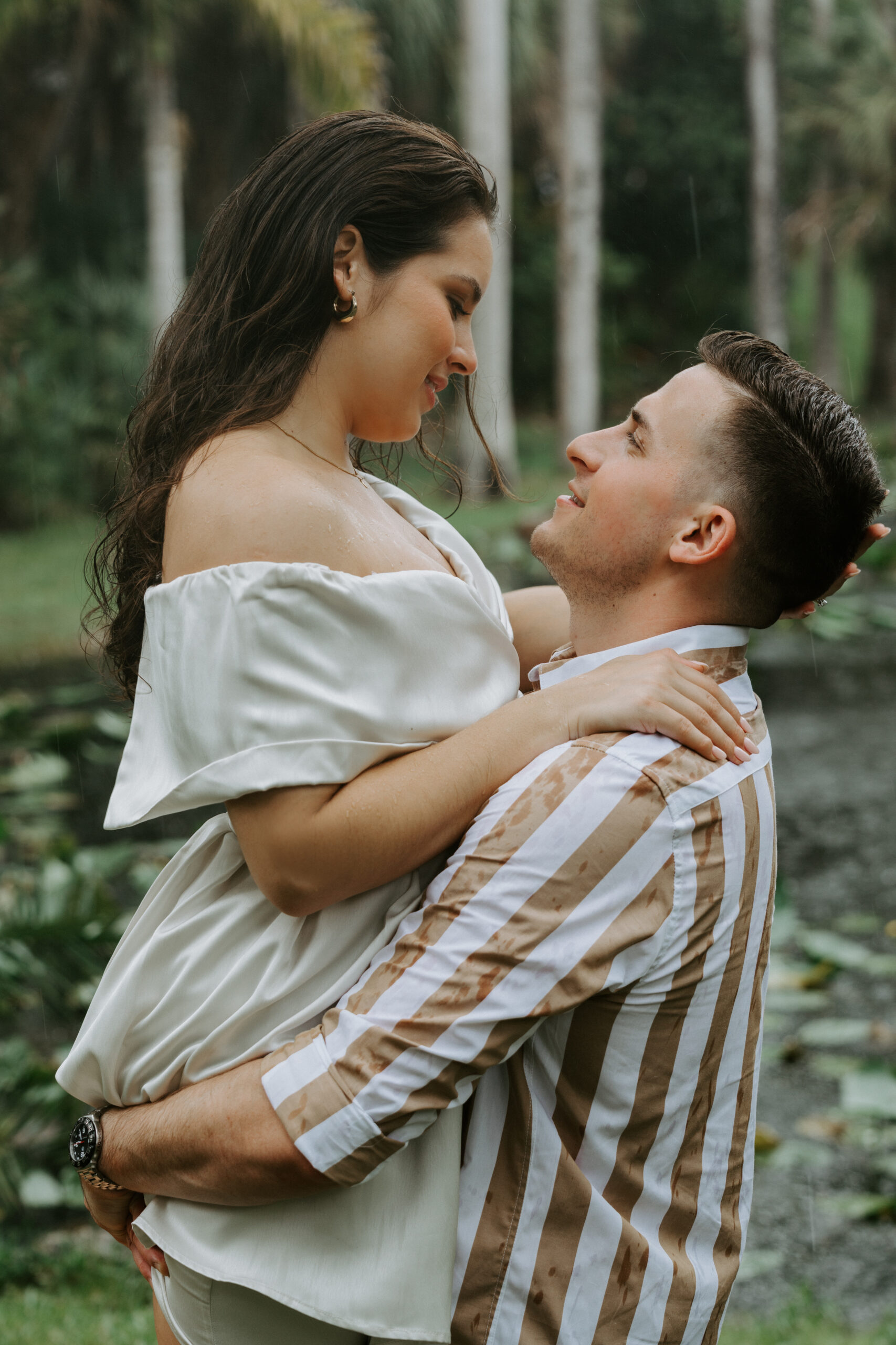 Couple holding each other at entrance to Bonnet House during engagement session in Fort Lauderdale, Florida.