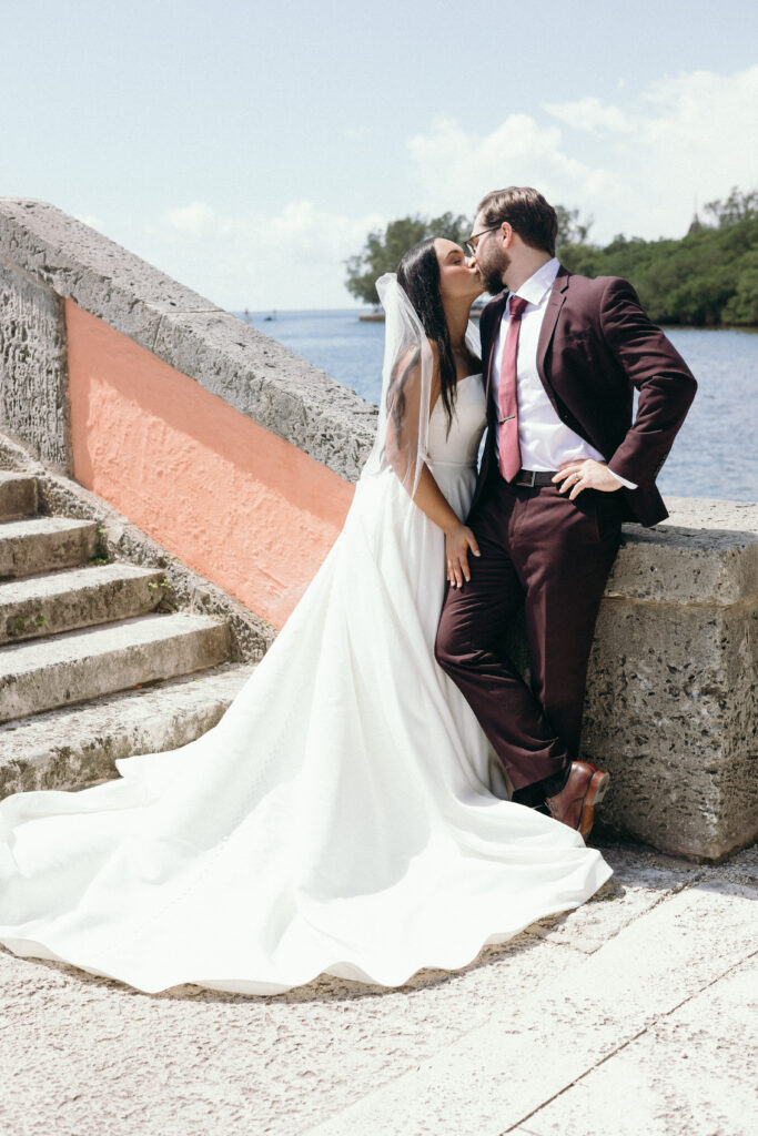 Bride and groom kiss at Vizcaya Museum and Gardens