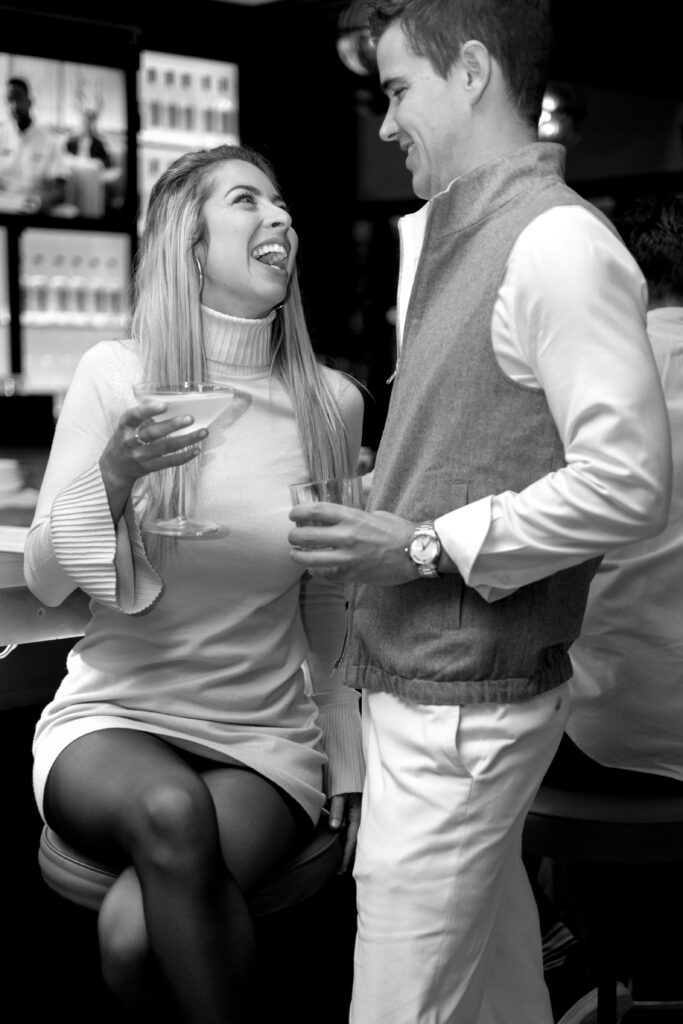 Couple laughing together at The Bellevue in Downtown Chicago during their engagement photoshoot in Chicago, Illinois. 