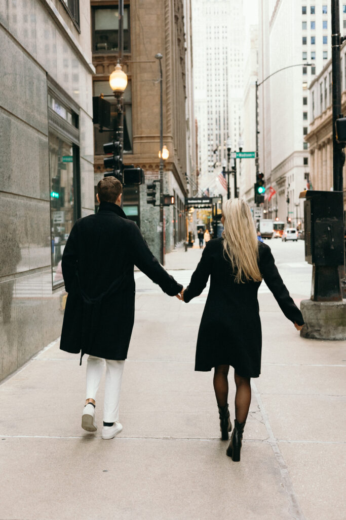 Couple walking through Downtown Chicago, Illinois during their engagement photoshoot. 