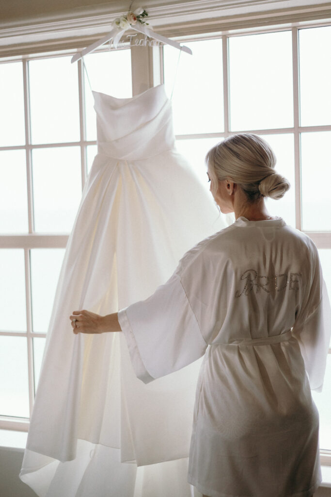 Bride looking at her dress while getting ready at The Ritz Carlton in Naples.