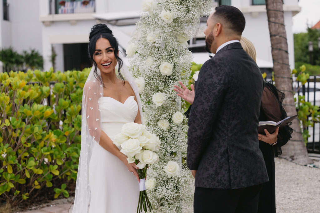 Bride laughing during her wedding ceremony at Naples Bay Resort in Naples, Florida. 