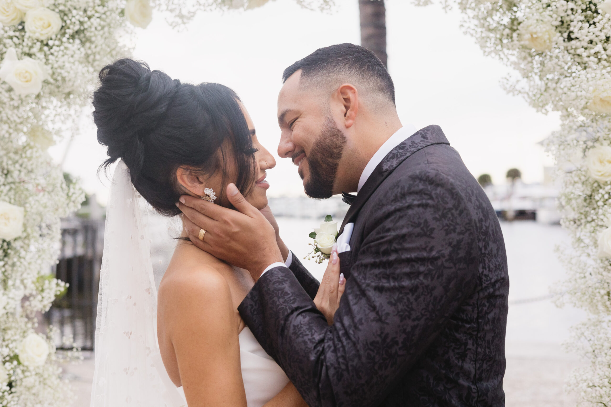 Bride and groom almost kissing during their wedding ceremony at Naples Bay Resort.