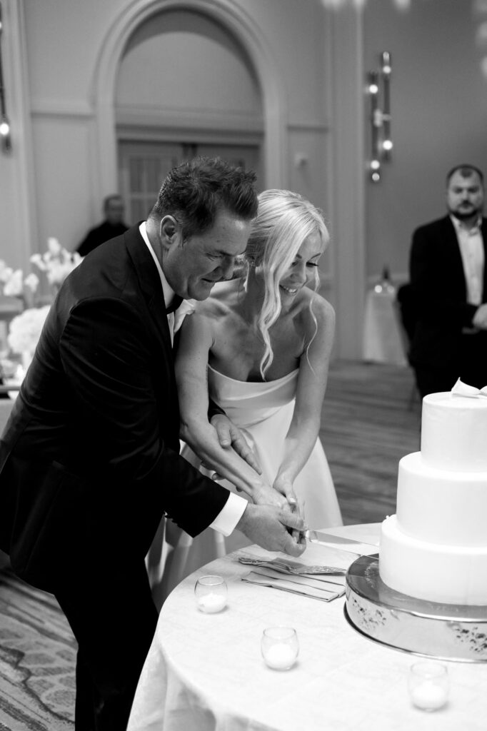 Bride and groom cake cutting at the Ritz Carlton wedding reception in Naples Florida