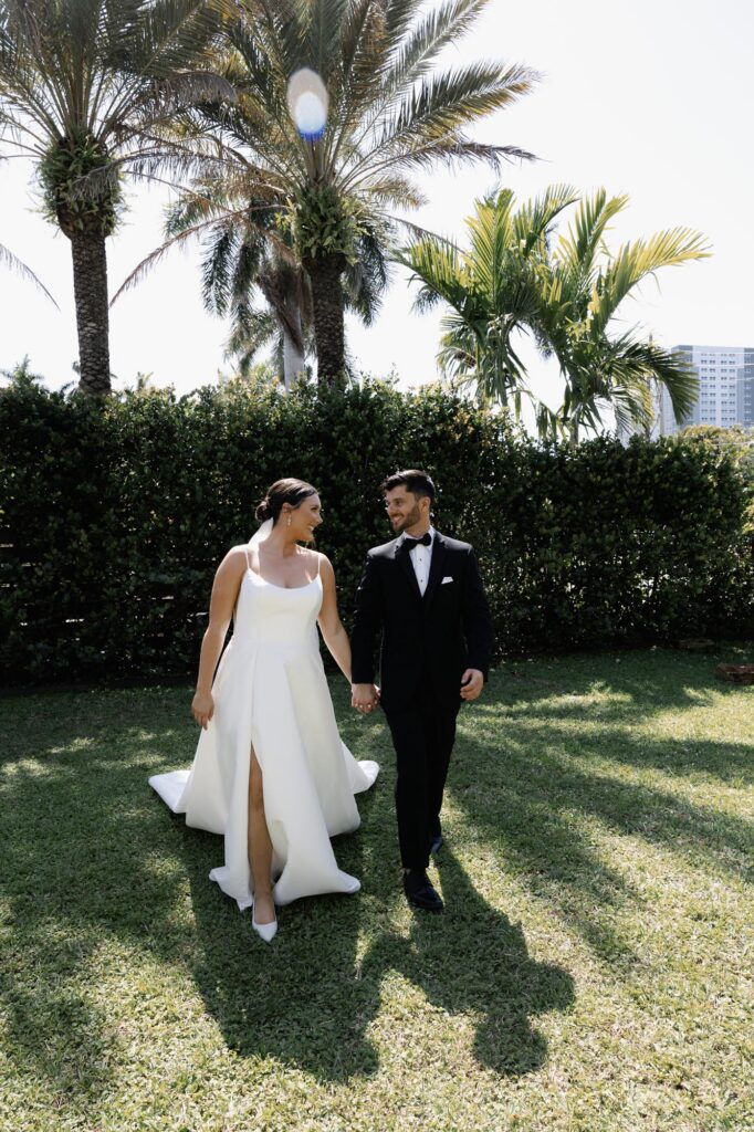 Bride and groom walking on lawn at their Alderman House wedding