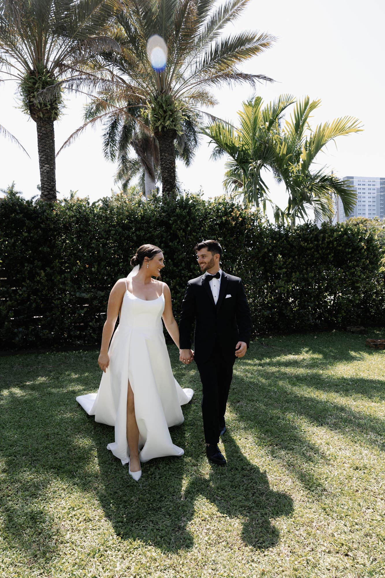 Bride and groom walking on lawn at their Alderman House wedding