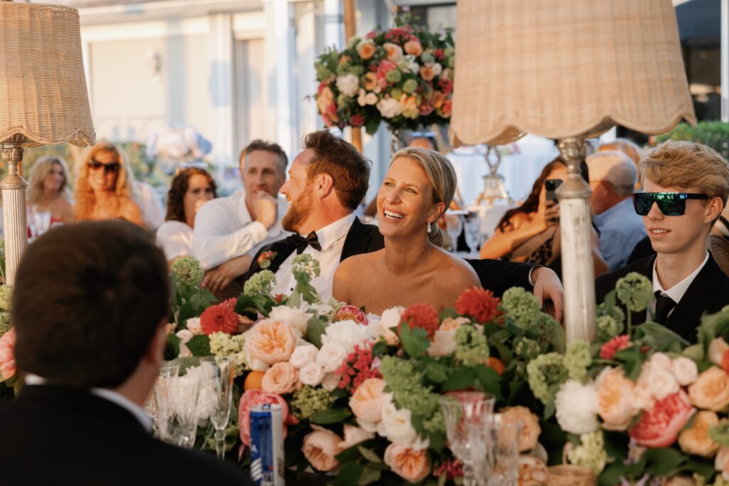 Luxury Port Royal Wedding | Priscila Del Cristo Photo Family toasts under string lights at port royal naples fl residence.