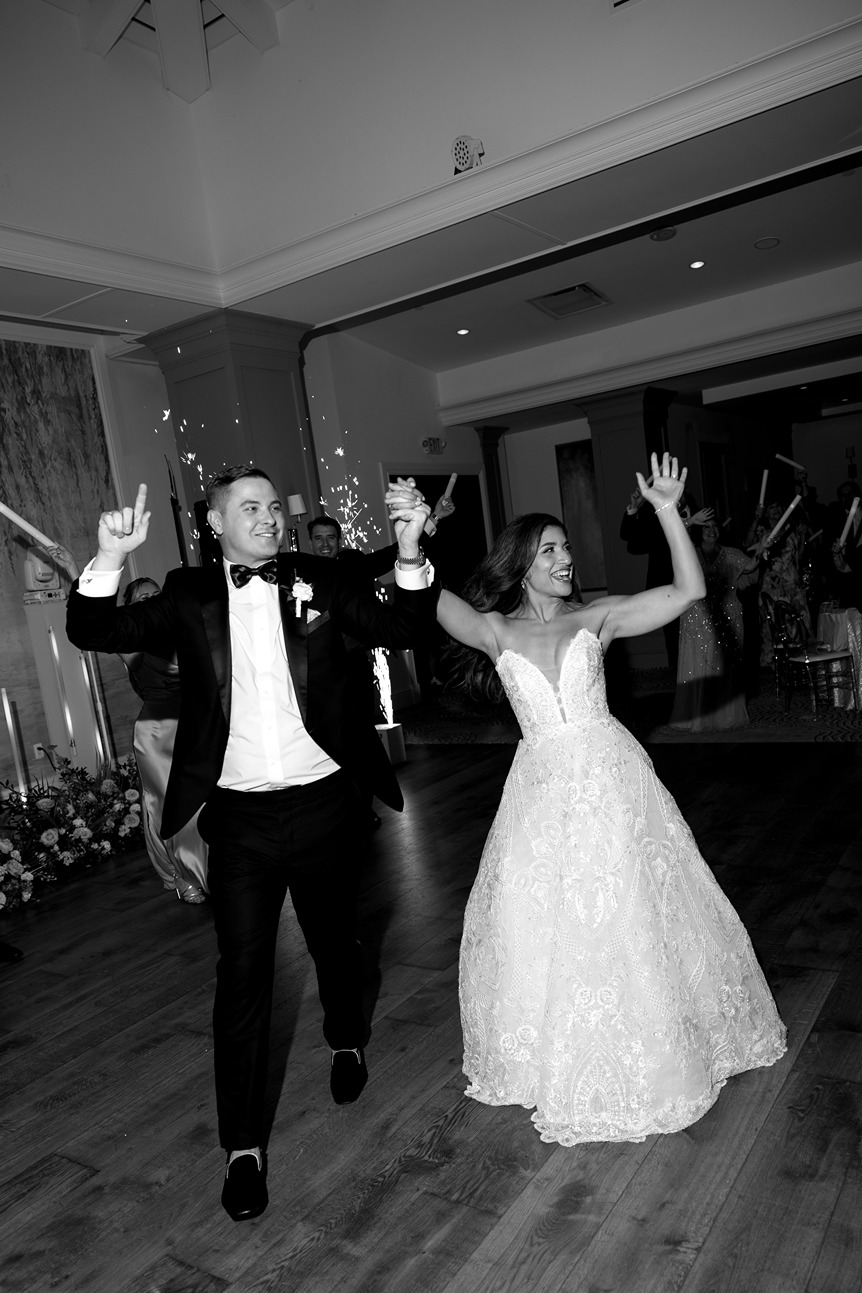 bride and groom walking into the naples beach hotel and golf club 