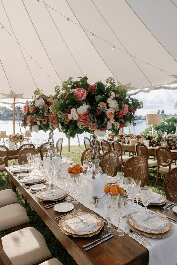 photgraph of an outdoor wedding reception setup under a tent at a november to april wedding in florida