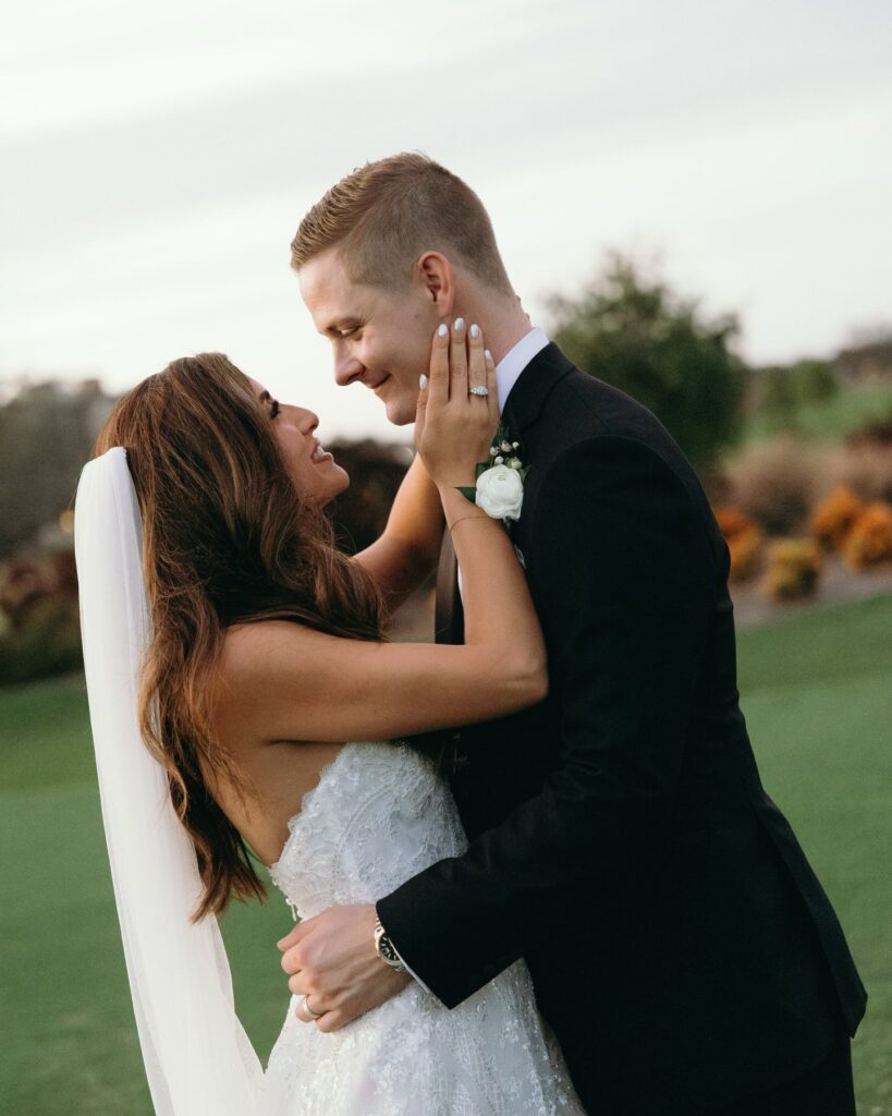bride and groom lovingly staring at each other during their portrait session at their floride outdoors wedding venue 