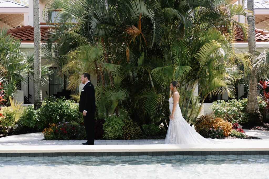 bride walking up to her groom for a first look, at their florida wedding, during warm er weather which is considered the best time to get married in florida