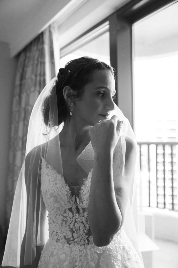 bride staring out the window at her florida wedding