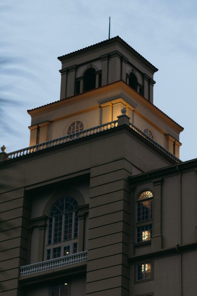 Architectural detail of an upscale Naples Florida wedding venue illuminated at dusk, highlighting refined coastal elegance often selected by a Naples wedding planner for sophisticated destination weddings.
