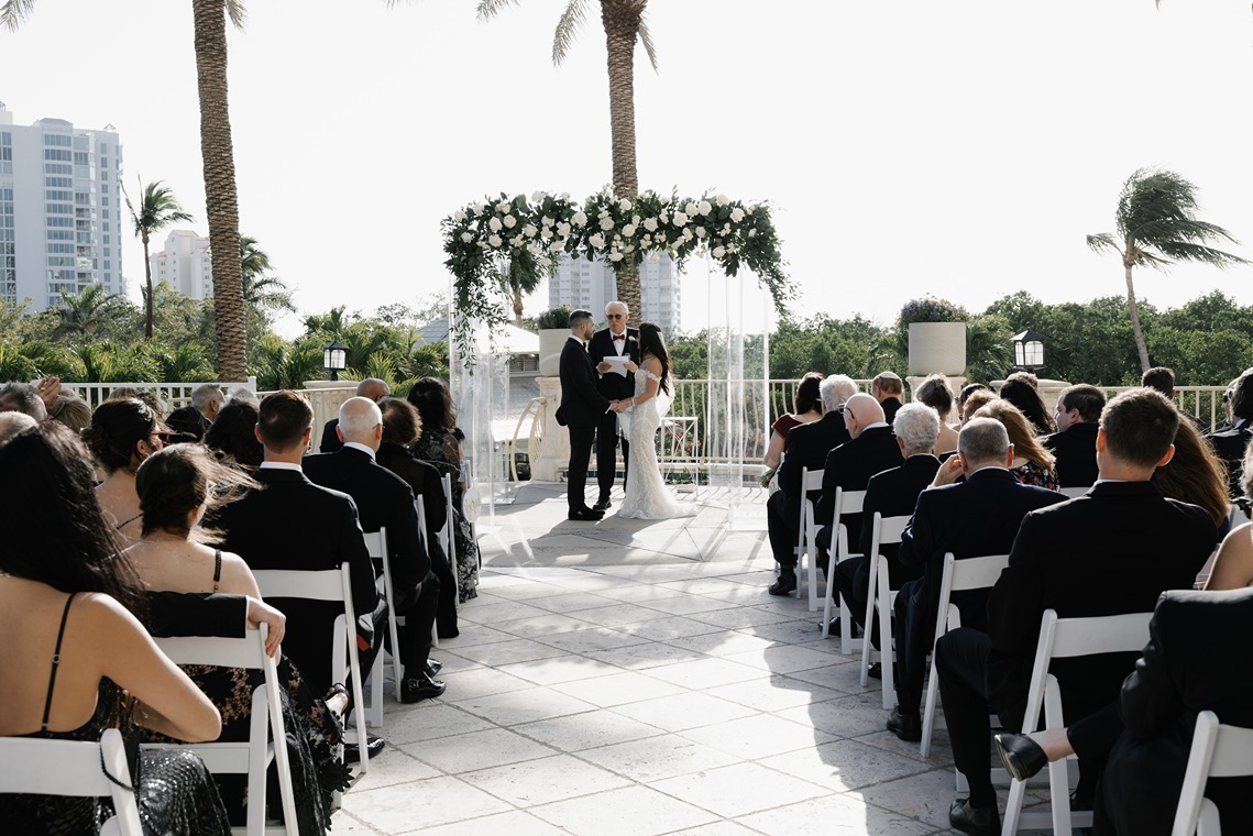 bride and groom exchanging vows during their wedding ceremony at one of the best outdoor wedding locations in naples, fl