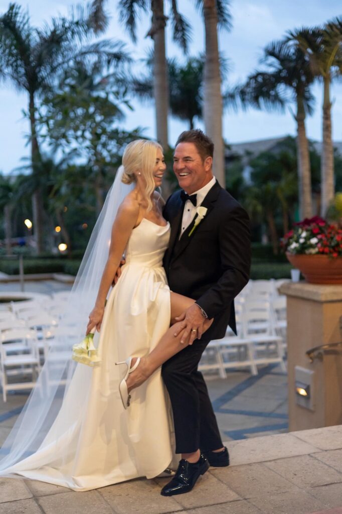 bride and groom sharing a fun moment at the ritz carlton, a luxury outdoor wedding venue in naples,fl