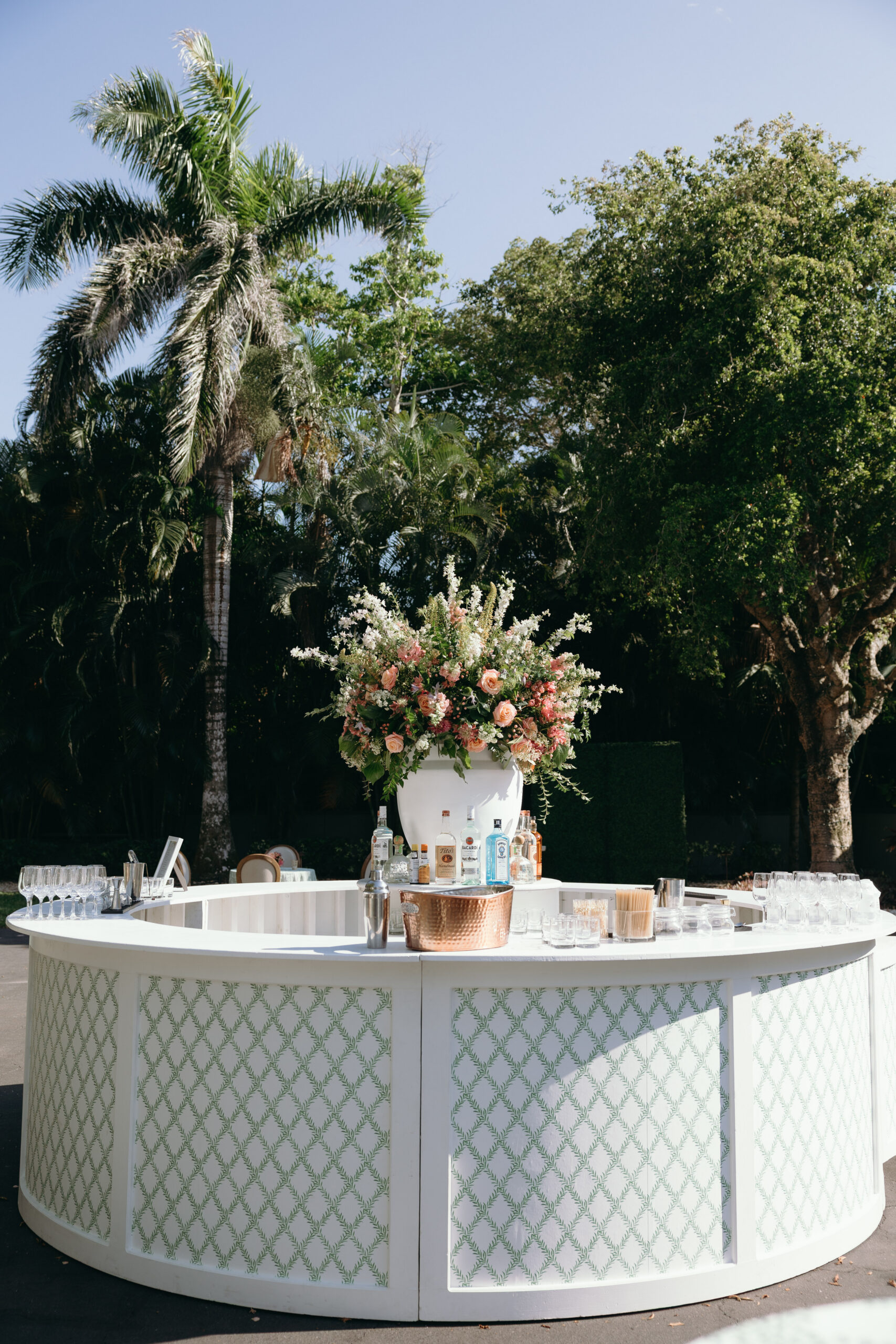 white bar with statement flowers at a naples wedding